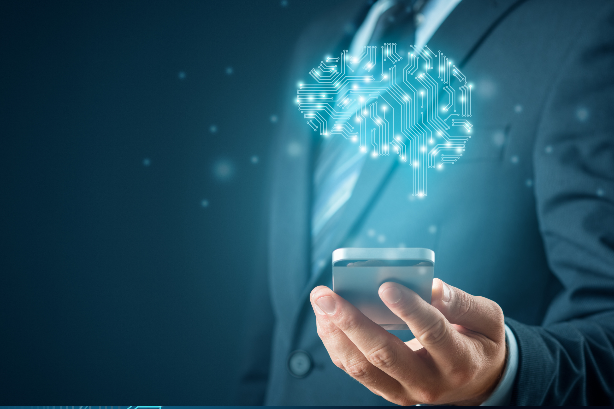 Male presenting person wearing a suit holding a cellular phone. You cannot see his face. Over the phone is a digital looking shaped image that is shaped like a brain. Auto attendants are an important part of small business phone systems.