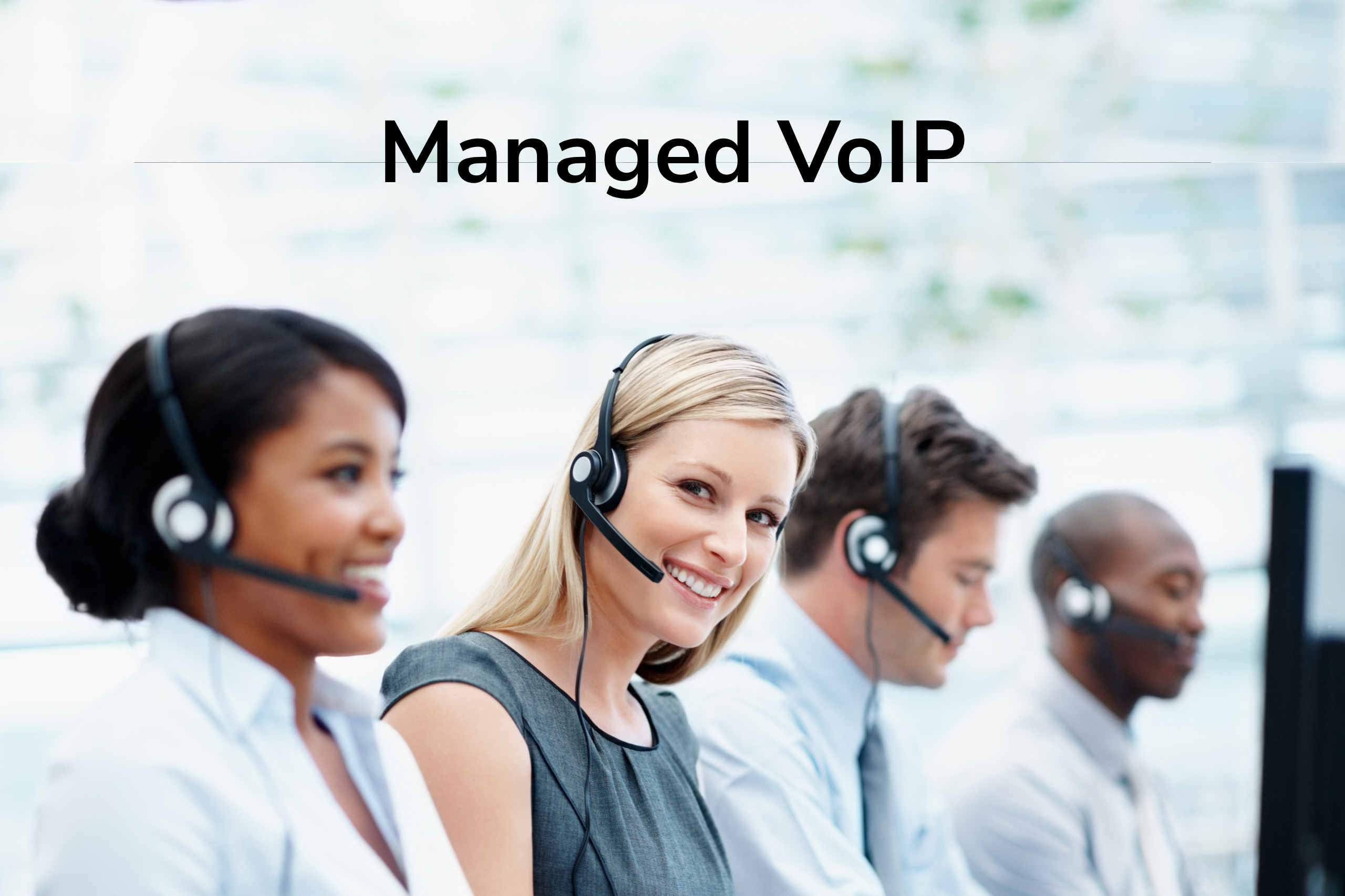 There is a line of customer service representatives, presumably from a VoIP company, they have headsets on and are smiling and it seems they are in the middle of active calls. The words "Managed VoIP" is written at the top of the picture.